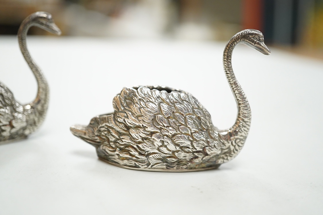 A pair of modern silver swan menu holders, maker E.A.W., Birmingham, 1975, height 44mm.